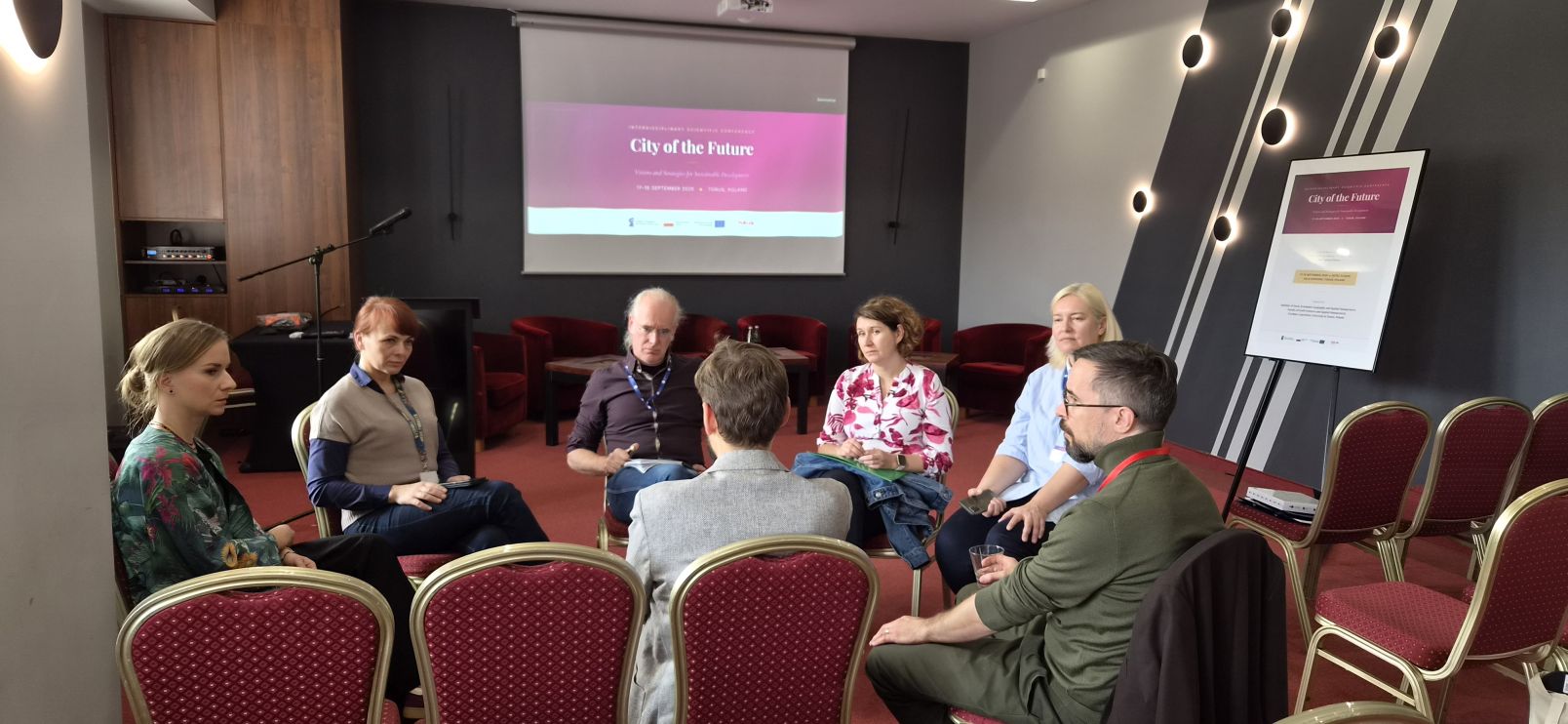 A group of people sitting in a circle, networking
