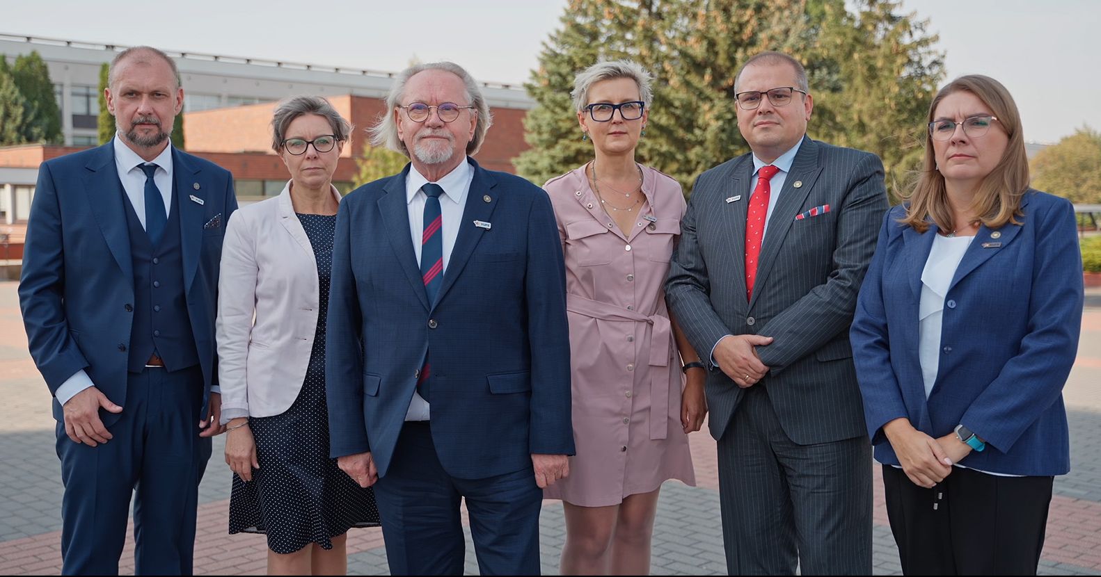  Members of the NCU Rector's College stand on the university campus.