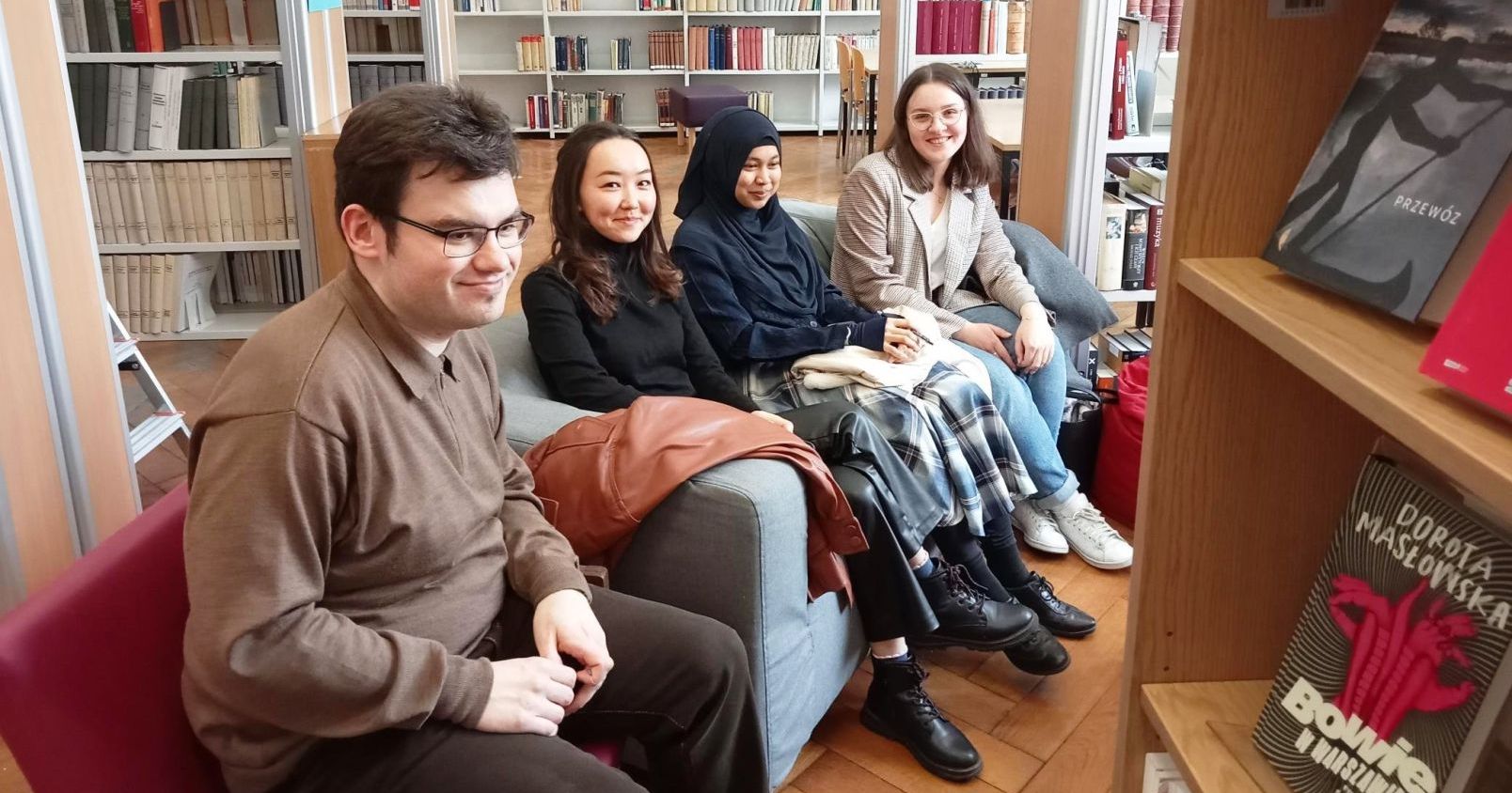  A group of international students on the background of bookshelves