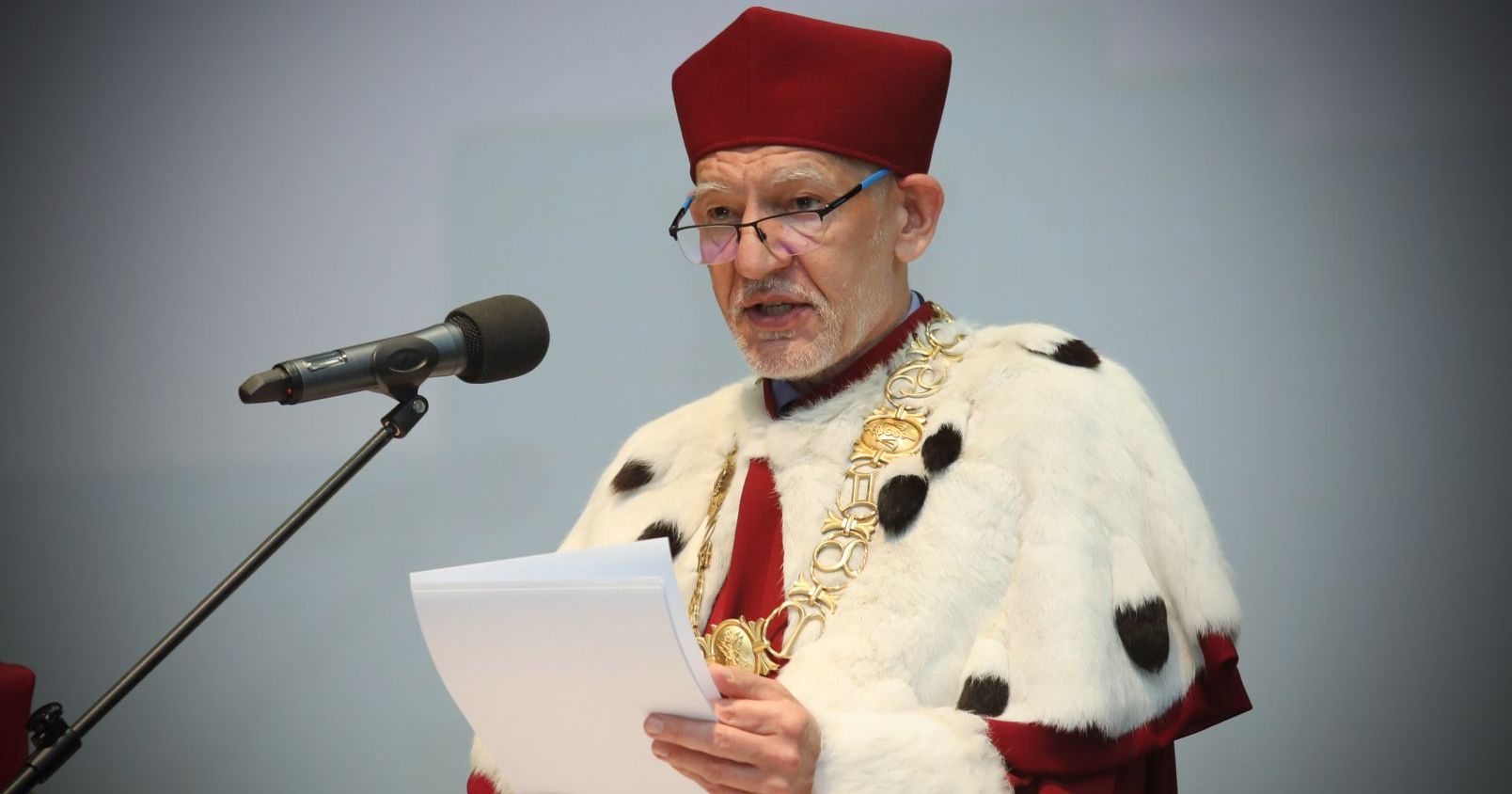  In the picture we can see NCU Rector holding some pages and talking to the microphone